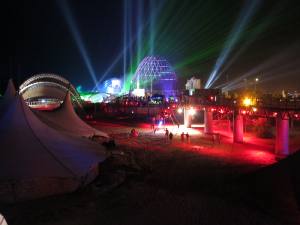 KaZantip Z21 at night with colorful lights and many sky beams